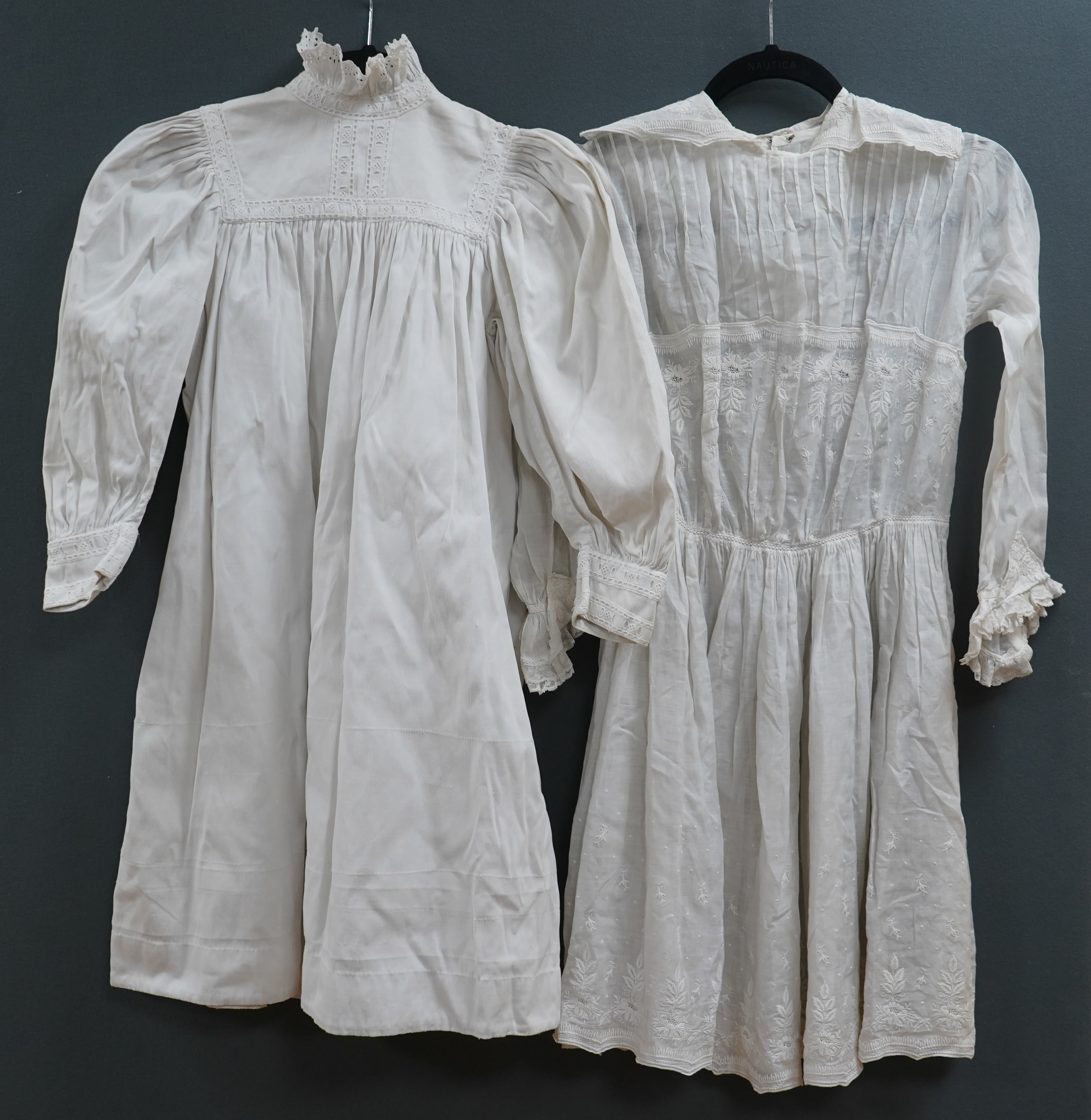 Two late 19th early 20th century girls summer dresses, one fine cotton with white worked collar cuffs and bodice, the other a cotton twill with anglaise collar large puff sleeves and gathered across the chest, lawn dress